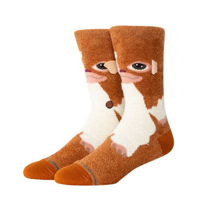A pair of plush stance gizmo crew socks featuring a gizmo from gremlins brown and white, shown against a plain white background.