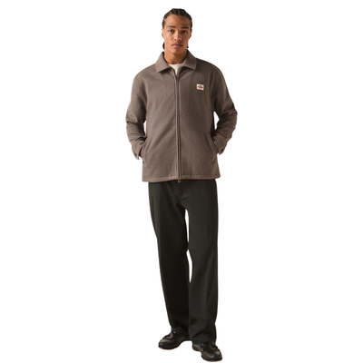 brown grey brixton trademark zip flannel jacket on a man in black pants on a white background