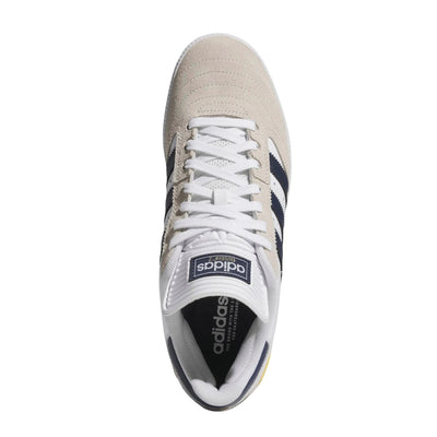 White adidas busenitz pro skateboard sneaker with navy stripes and yellow accent on a white background