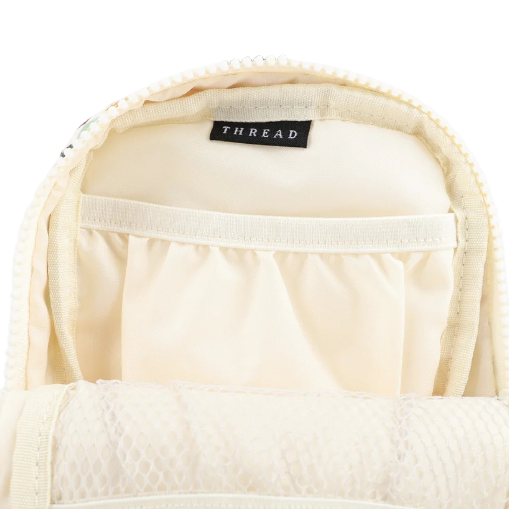 inside of a multi colored checkered thread crossbody bag on a white background