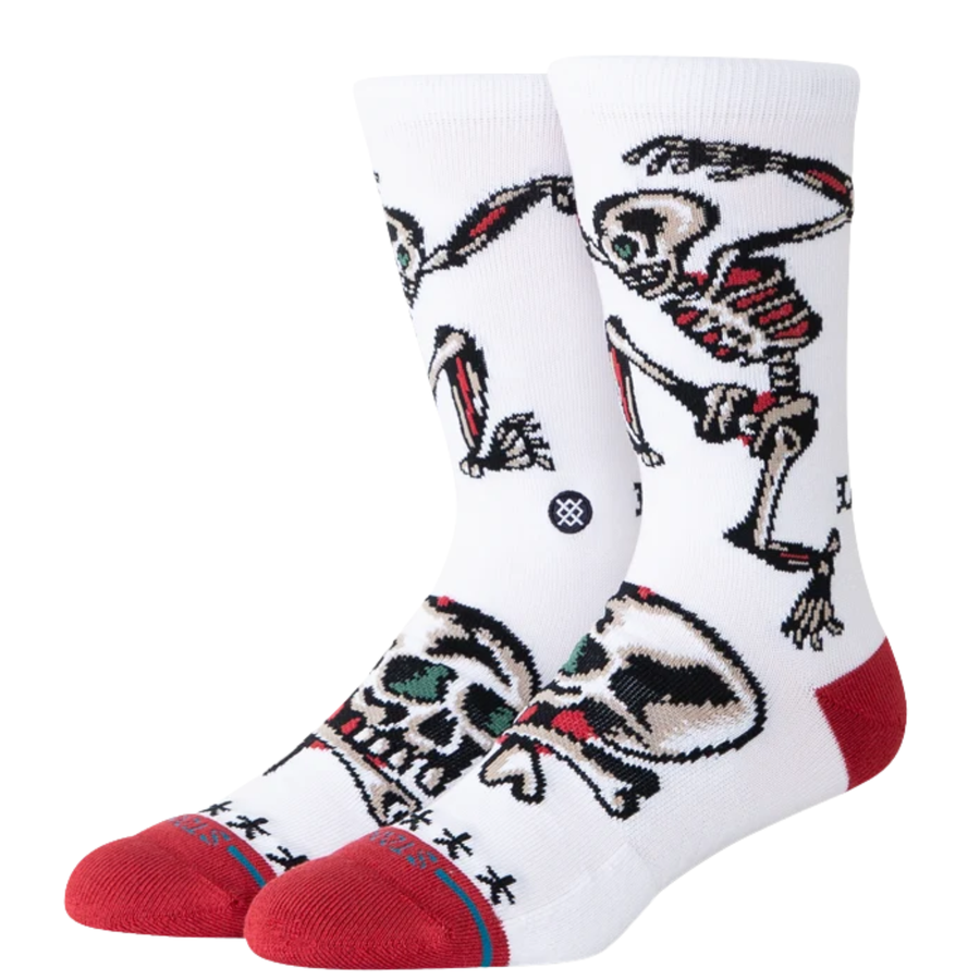 white stance x bert krak crew socks wth a skeleton and skulls and a red toe and heel on a white background