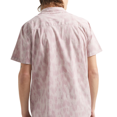 Man wearing a pink brixton charter print patterned short sleeve shirt with brand logo on a white background