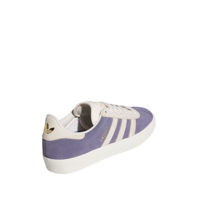 purple adidas gazelle adv skateboard shoe with white stripes on a white background