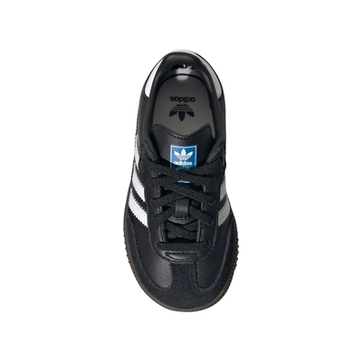 top view of A single Adidas Samba kids sneaker in black leather with signature white side stripes, a gold 'SAMBA' text on the side, and a dark brown gum sole, shown against a plain white background.
