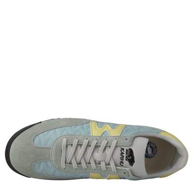 grey and blue karhu mestari Sneaker with a yellow 'M' logo on a white background