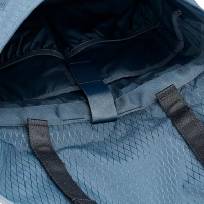 Blue herschel cove messenger bag with a black strap on a white background