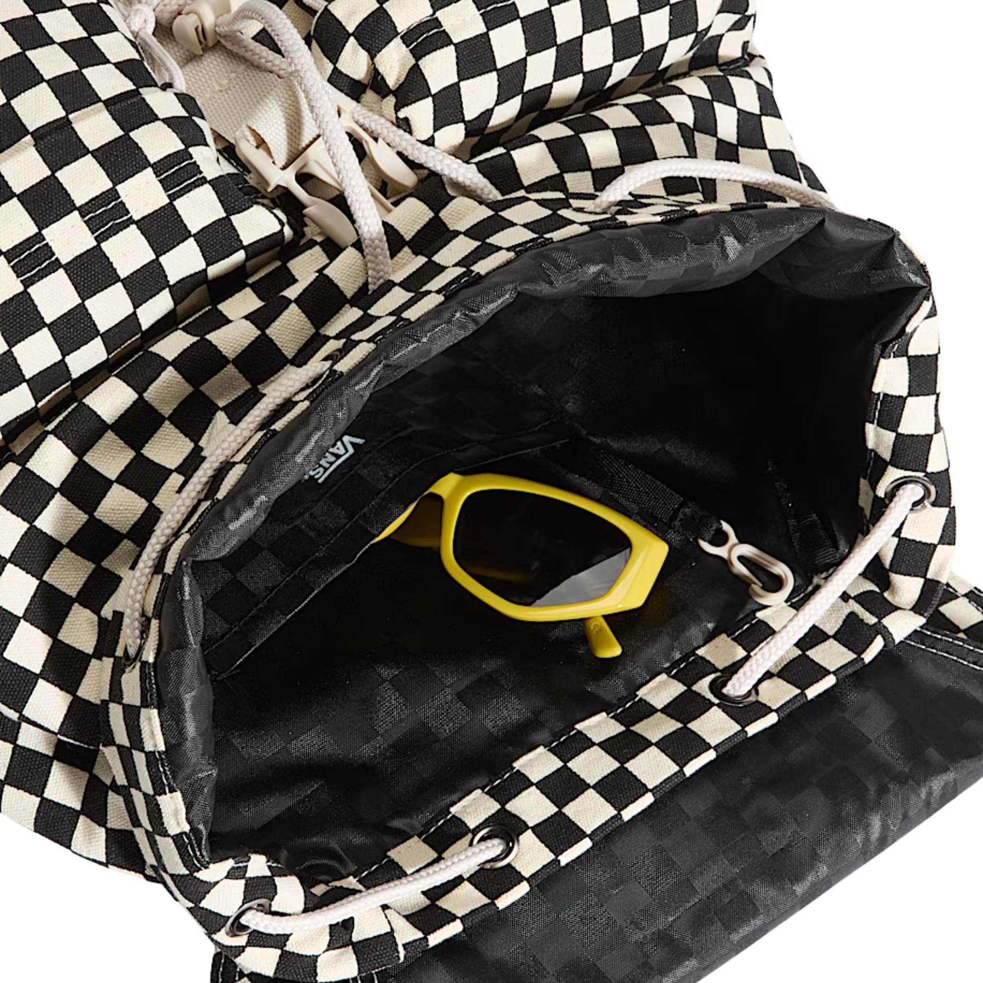 A black and white vans scatter checkerboard patterned backpack with a cream-colored top handle and front strap closure, shown against a plain white background.