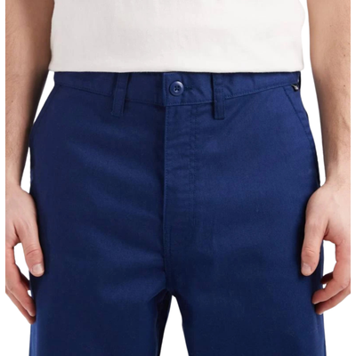 Navy blue vans pants worn by a person on a white background