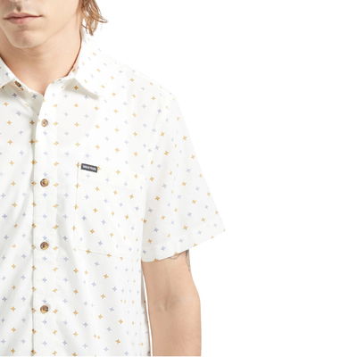 Man wearing a white brixton charter print short-sleeve shirt with a subtle pattern on a white background