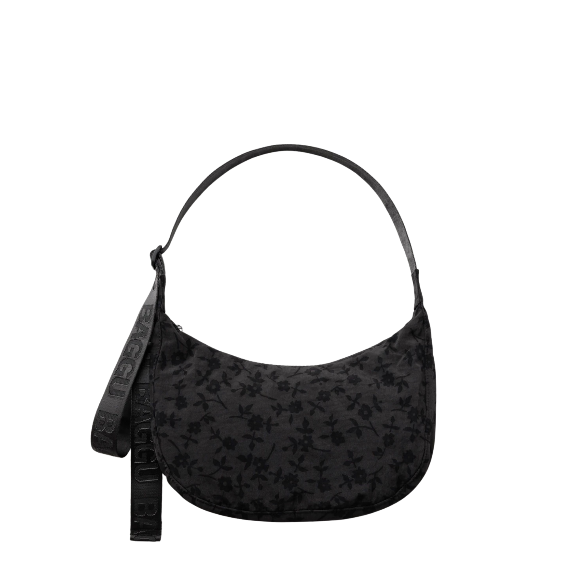 A black crescent-shaped baggu shoulder bag with a subtle tonal floral pattern, featuring a matching black strap with embossed lettering, shown against a plain white background.