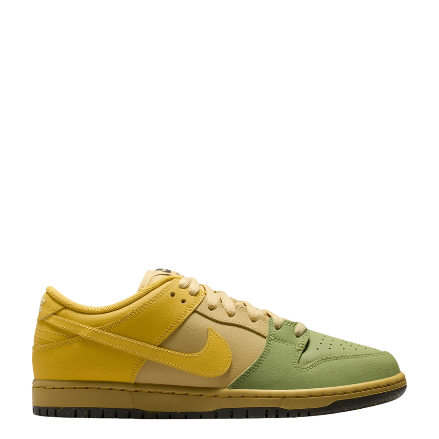 A Nike SB Saffron Dunk Low sneaker in a yellow, tan, and sage green colorway, shown from a side profile view against a plain white background.