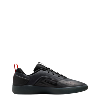 A black Nike nyjah 4 skateboard sneaker with a textured synthetic upper, black laces, a black sole, and a small red pull tab on the heel, shown from a side profile against a white background.