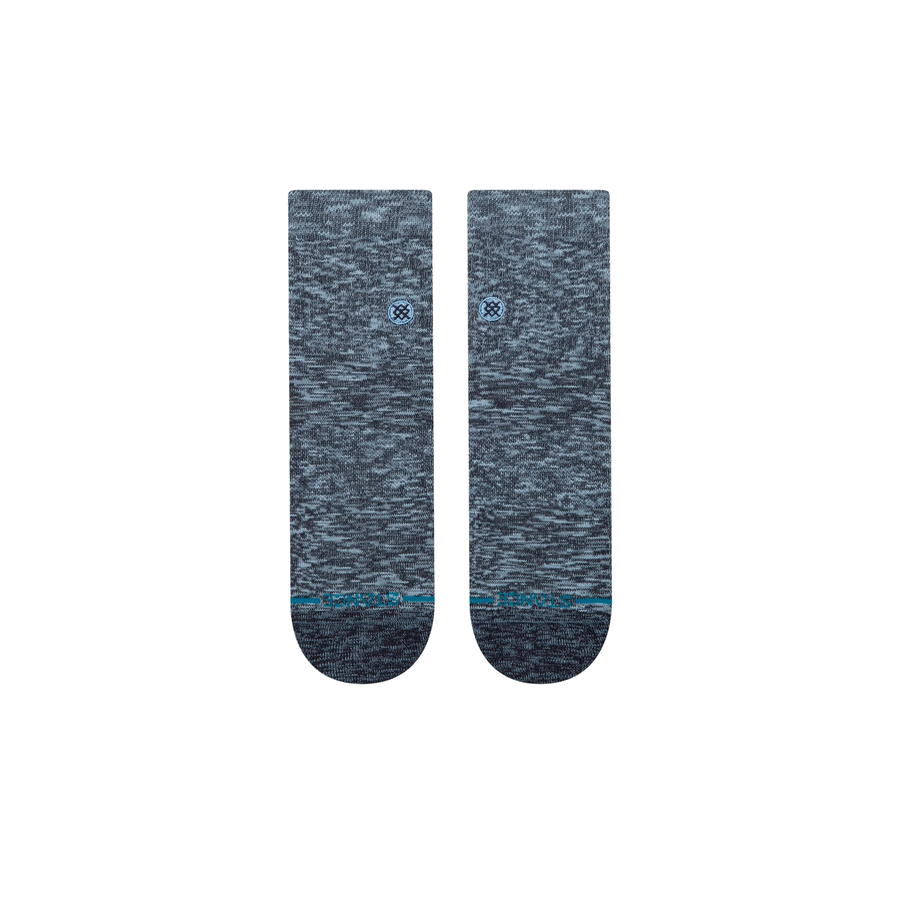 A pair of Stance slub quarter socks in a heathered slate blue and gray colorway, featuring a small blue logo on the side and a thin teal stripe near the toe, shown against a plain white background.