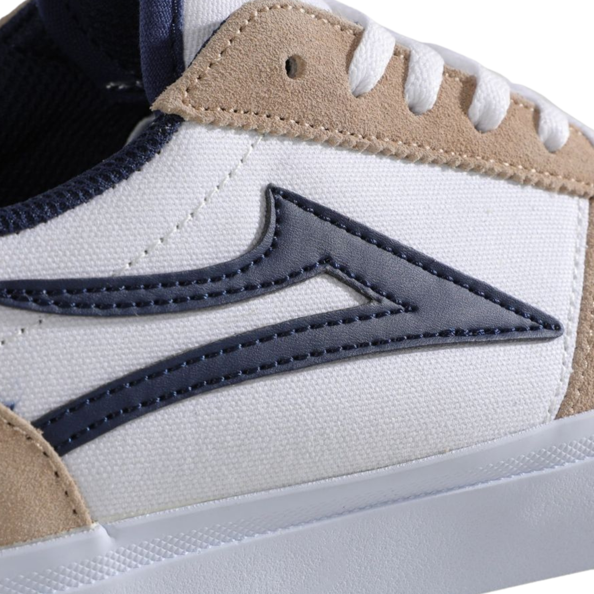 Beige and white lakai manchester skateboard sneaker with a blue logo on a white background