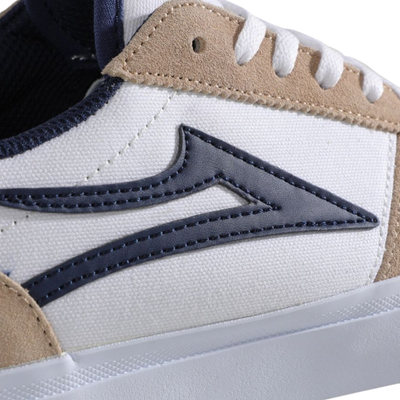 Beige and white lakai manchester skateboard sneaker with a blue logo on a white background