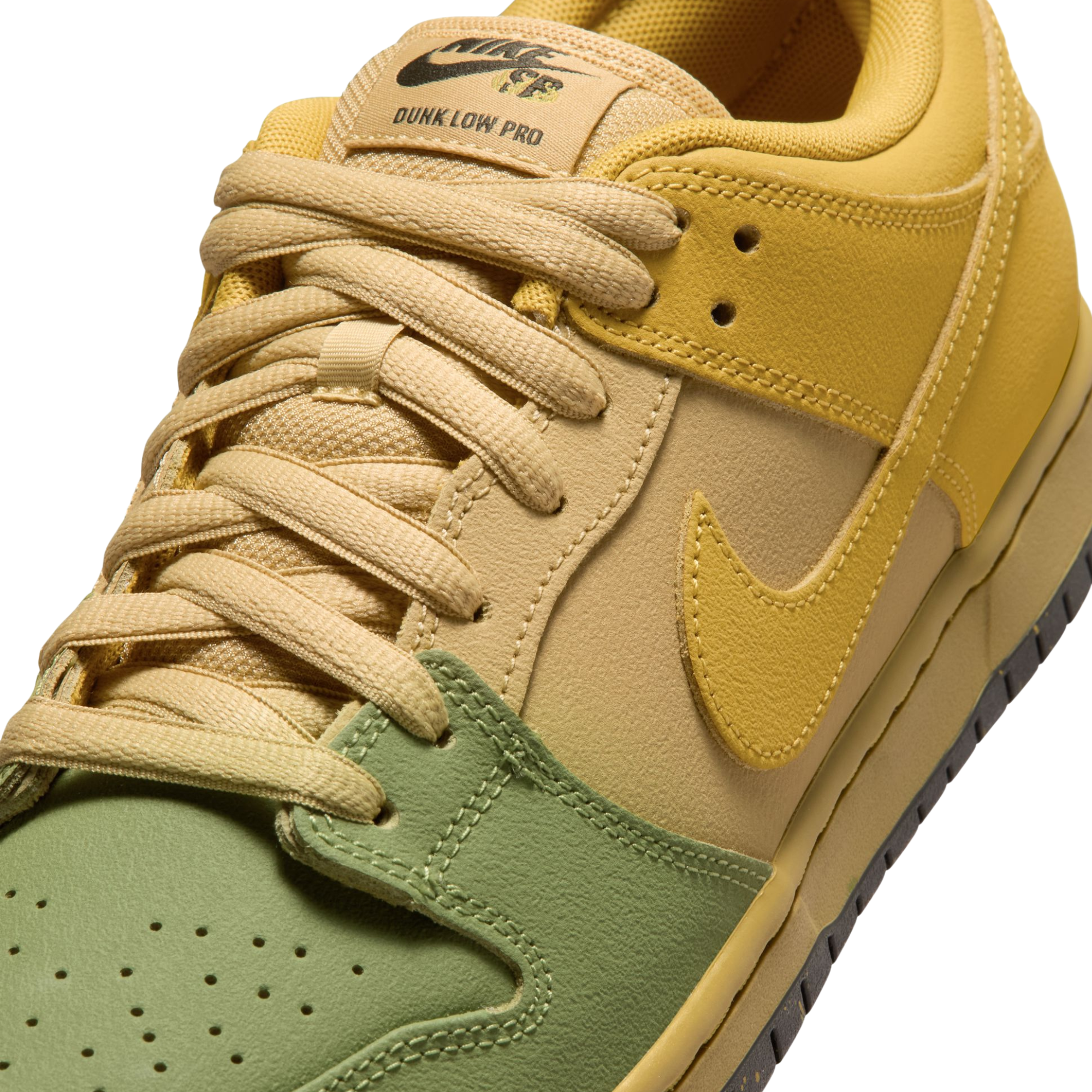 A Nike SB Saffron Dunk Low sneaker in a yellow, tan, and sage green colorway, against a plain white background.