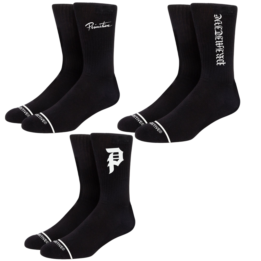 Three pairs of black crew socks with white branding details, arranged on a plain white background. The top-left pair shows the word 'Primitive' in script, the top-right pair shows 'PRIMITIVE' in a vertical gothic font, and the bottom pair shows a stylized white 'P' logo.