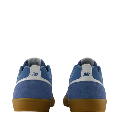 blue men's new balance numeric jamie foy 306 skate shoe with grey details and gum sole on a white background