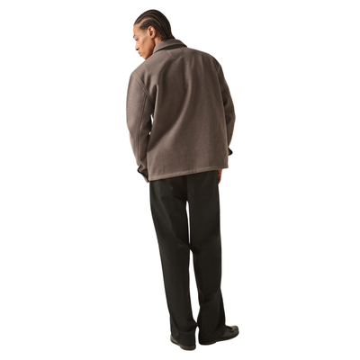 brown grey brixton trademark zip flannel jacket on a man in black pants on a white background