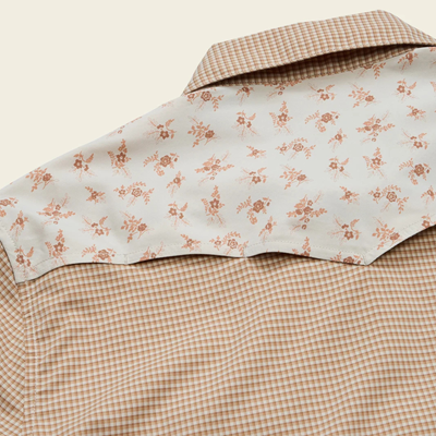 close up of the back of A beige and brown checkered long-sleeve howler h bar tech western shirt with beige floral patterned yoke panels on the shoulders, featuring two buttoned chest pockets and a button-down front.