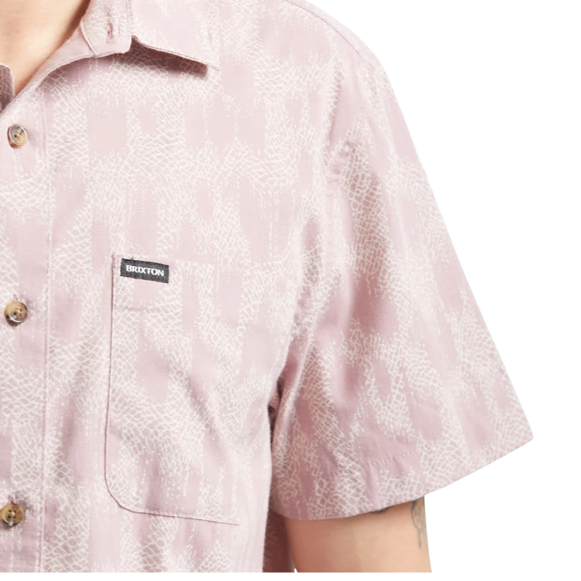 Close-up of s Man wearing a pink brixton charter print patterned short sleeve shirt with brand logo on a white background