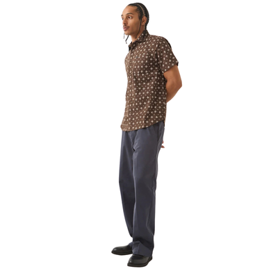 brown brixton men's charter print short sleeve woven button-up shirt with a bandana pattern on a man on a white background