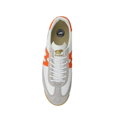 White karhu mestari 76 sneaker with orange 'M' logo on a white background