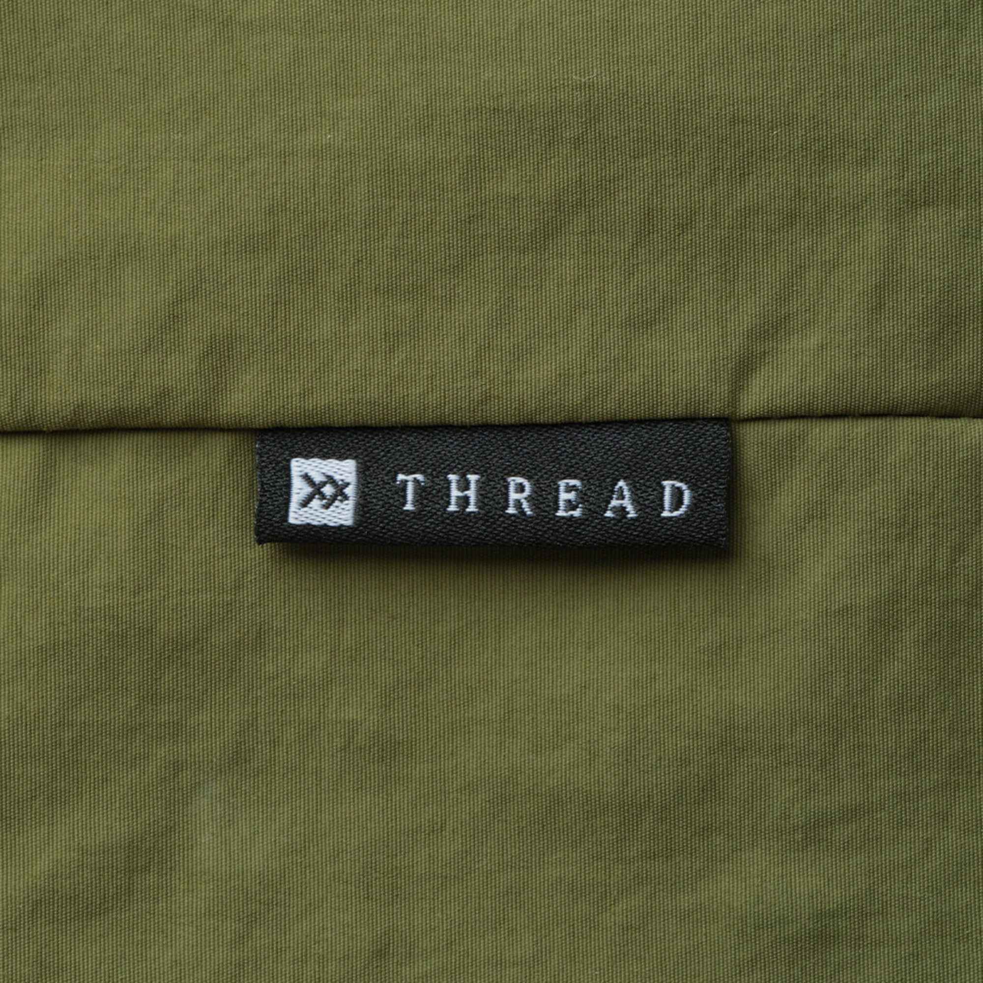 Green thread slouchy shoulder bag on a white background