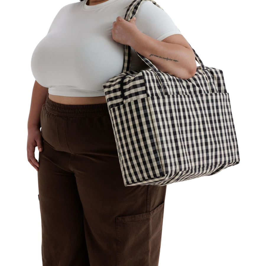 A black and white gingham checkered baggu cloud carry on tote bag with two shoulder straps, shown against a plain white background.