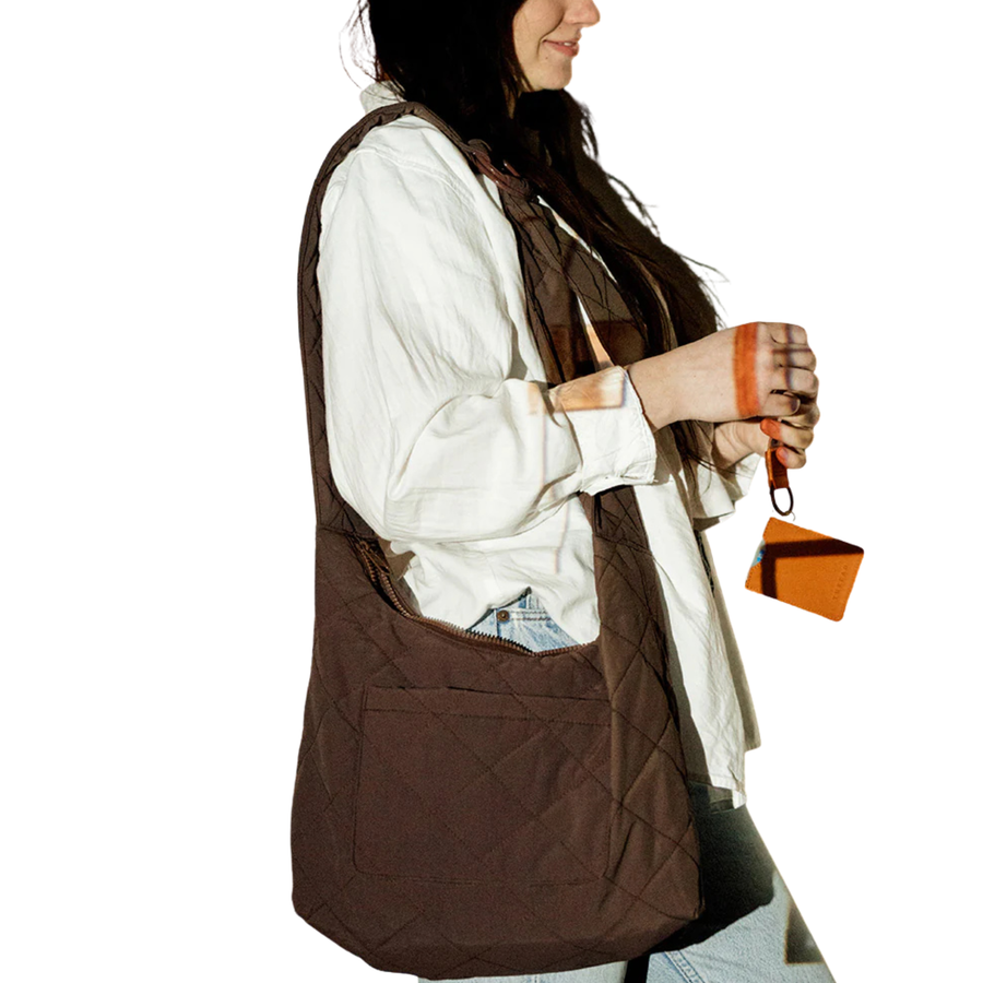 Brown quilted thread slouchy shoulder bag on a white background