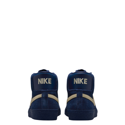 A high-top Nike sb Blazer skateboard sneaker in navy blue suede with a beige Swoosh logo and matching navy laces, shown from a side profile on a white background.