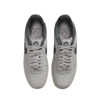 Nike sb x Yuto Air Force 1 Low skateboard sneakers in light gray and dark gray, featuring a light gray leather upper, dark gray Swoosh, and a cream midsole with a black outsole from above