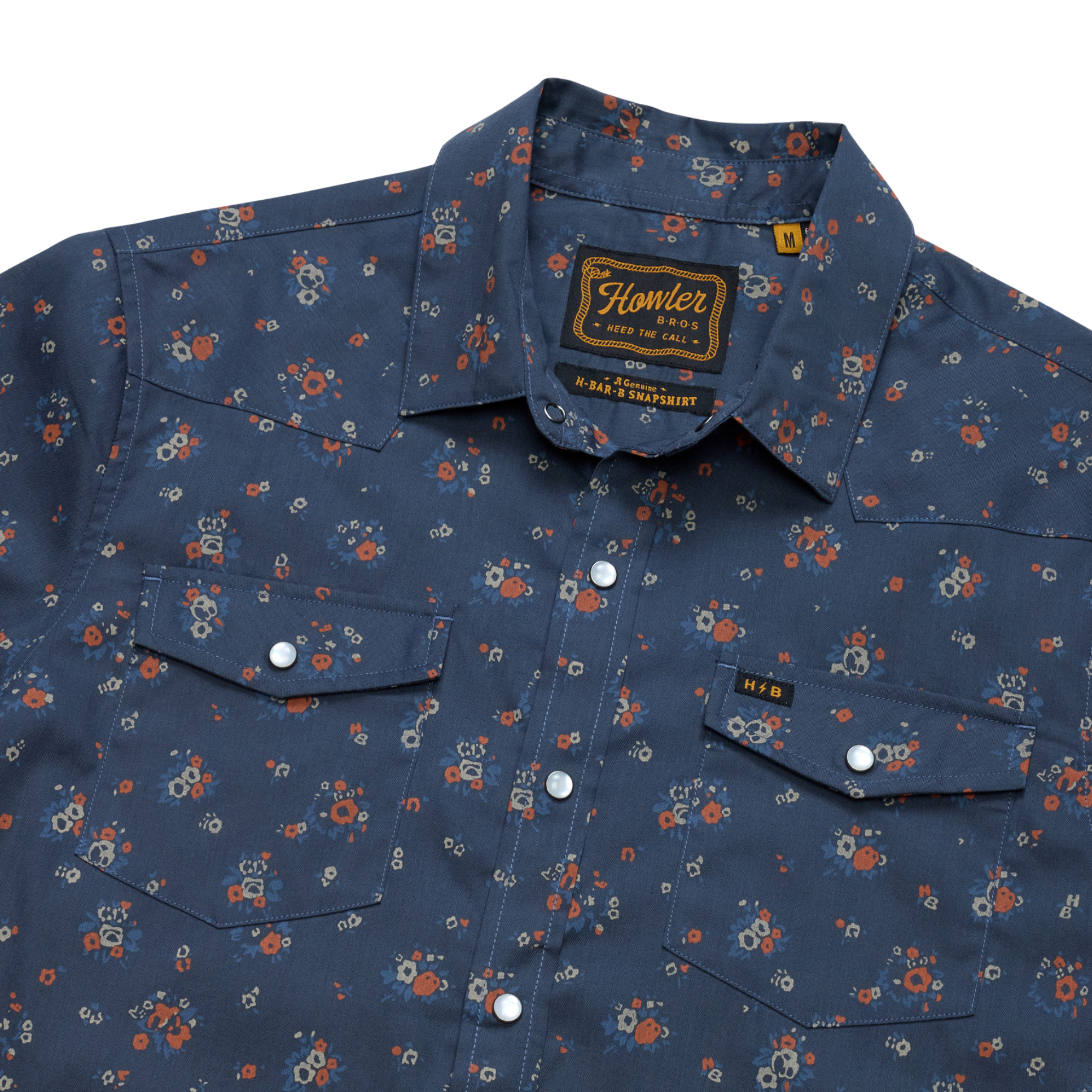 close up of a Holwer Brothers H Bar B Snapshirt Bouquets in a midnight blue wiht small all-over floral print on a white background