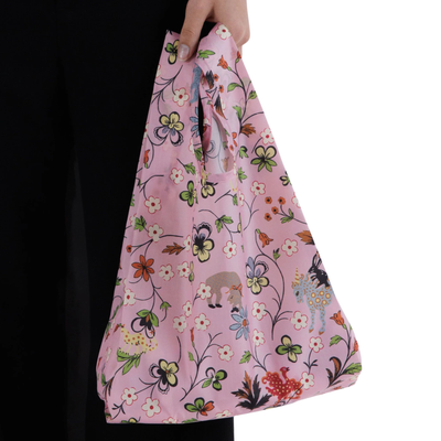pink baby baggu reusable tote with a floral design being held in someone's hand on a white background