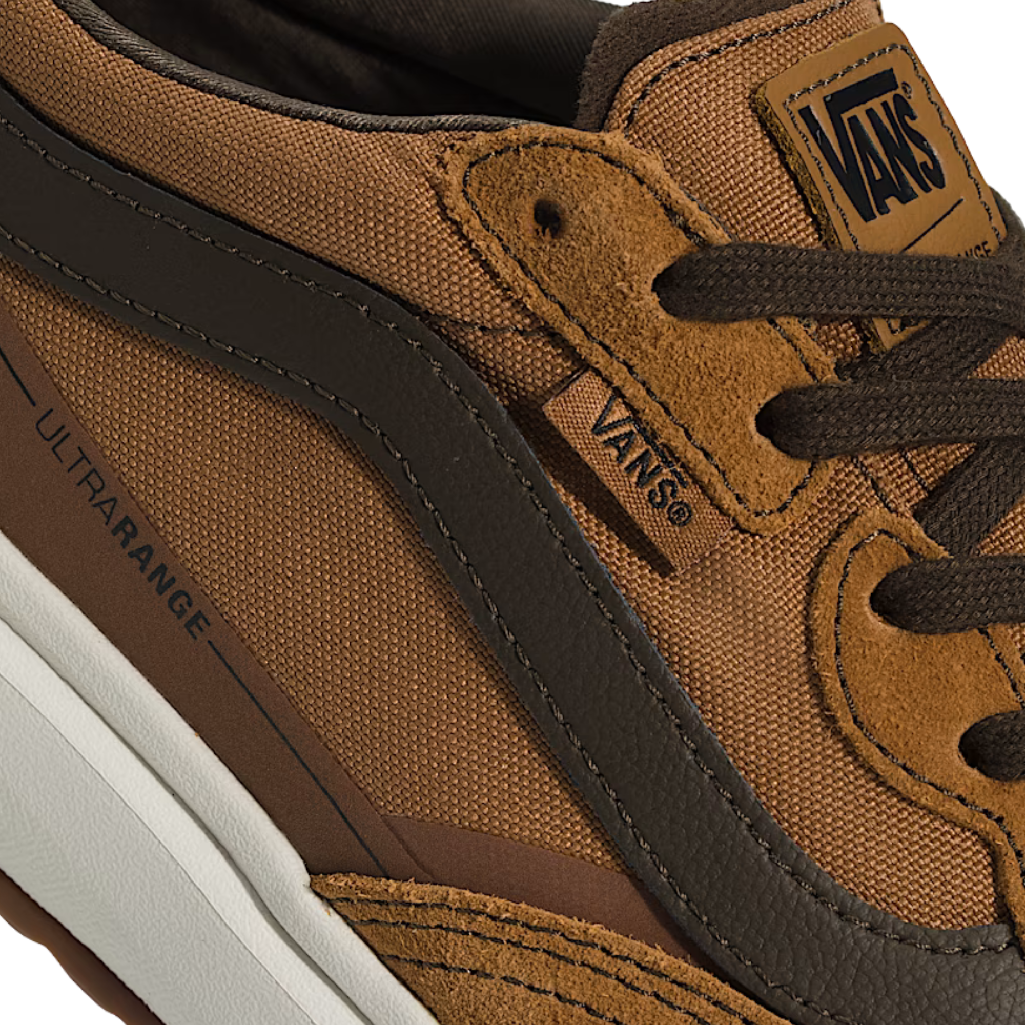 Close-up of a brown Vans sneaker with visible branding.
