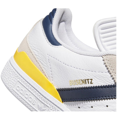 White adidas busenitz pro skateboard sneaker with navy stripes and yellow accent on a white background