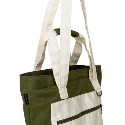 Green thread scout tote bag with a white pocket and strap on a white background