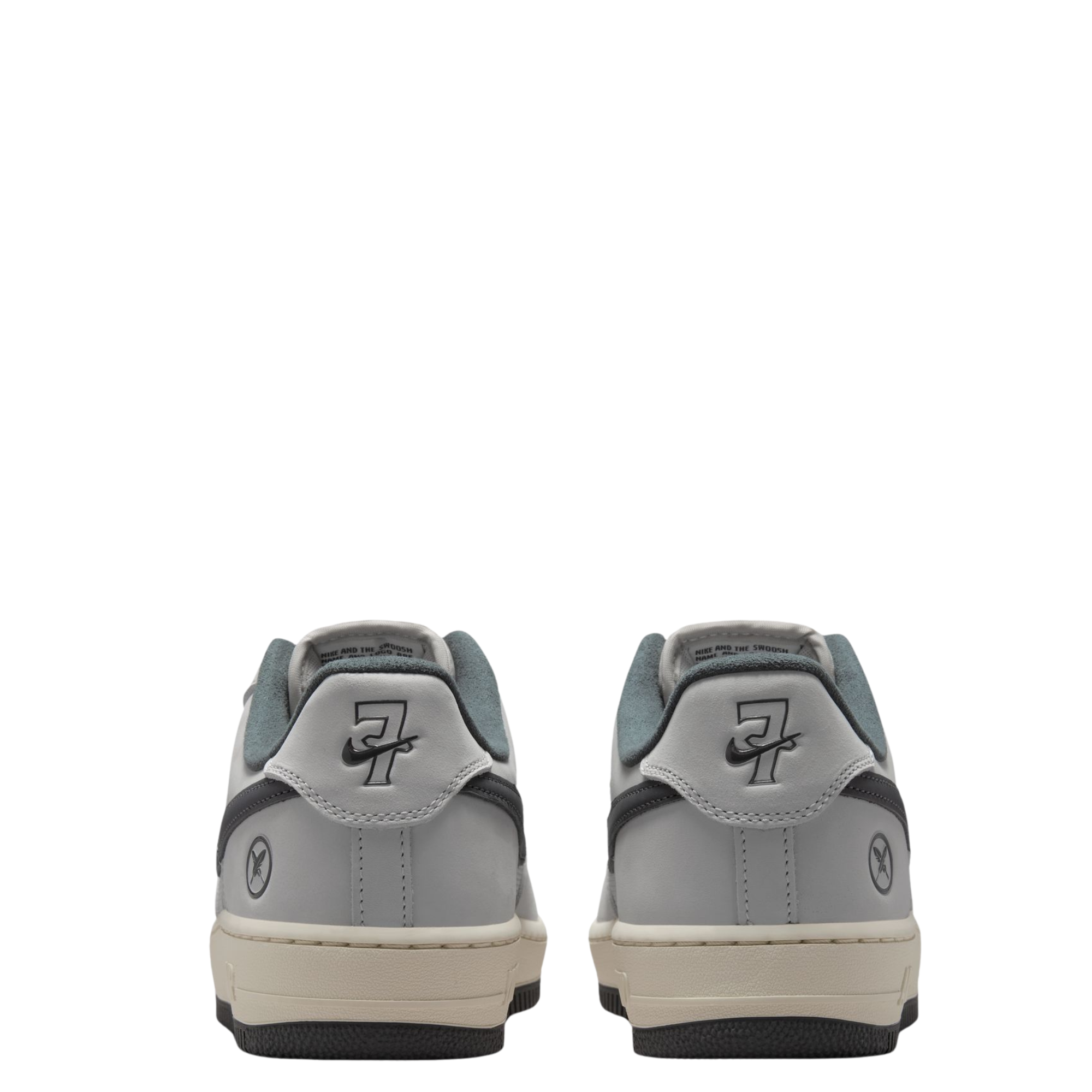 a pair of Nike sb x Yuto Air Force 1 Low skateboard sneakers in light gray and dark gray, featuring a light gray leather upper, dark gray Swoosh, and a cream midsole with a black outsole showing the number seven with the nike swoosh through it