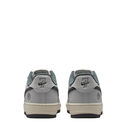 a pair of Nike sb x Yuto Air Force 1 Low skateboard sneakers in light gray and dark gray, featuring a light gray leather upper, dark gray Swoosh, and a cream midsole with a black outsole showing the number seven with the nike swoosh through it