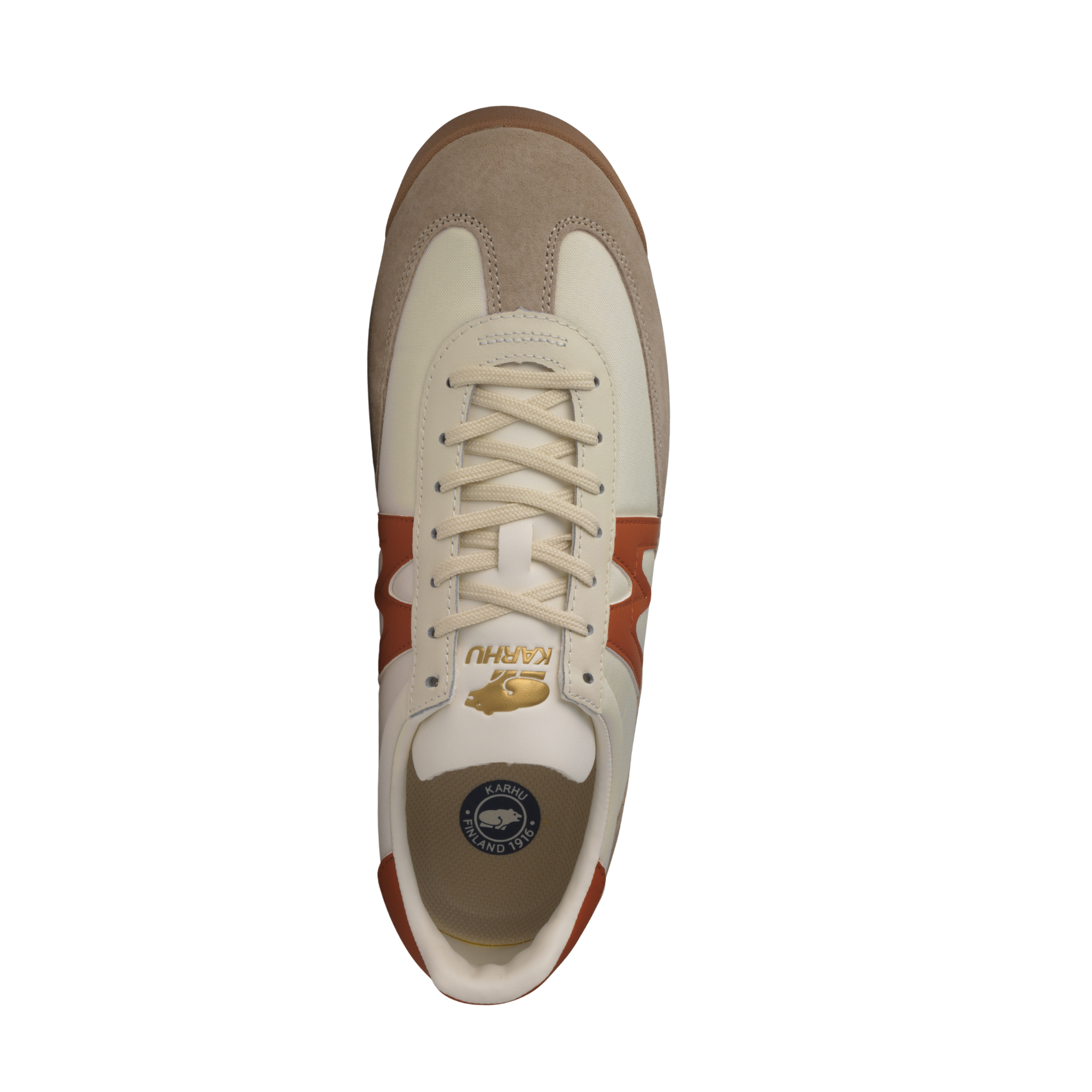 A low-top karhu mestari sneaker in beige suede and off-white leather with a prominent rust-orange 'M' logo on the side, a matching heel tab, and a beige midsole.