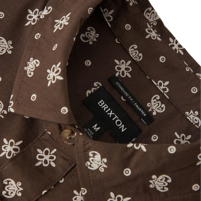 brown brixton men's charter print short sleeve woven button-up shirt with a bandana pattern on a white background