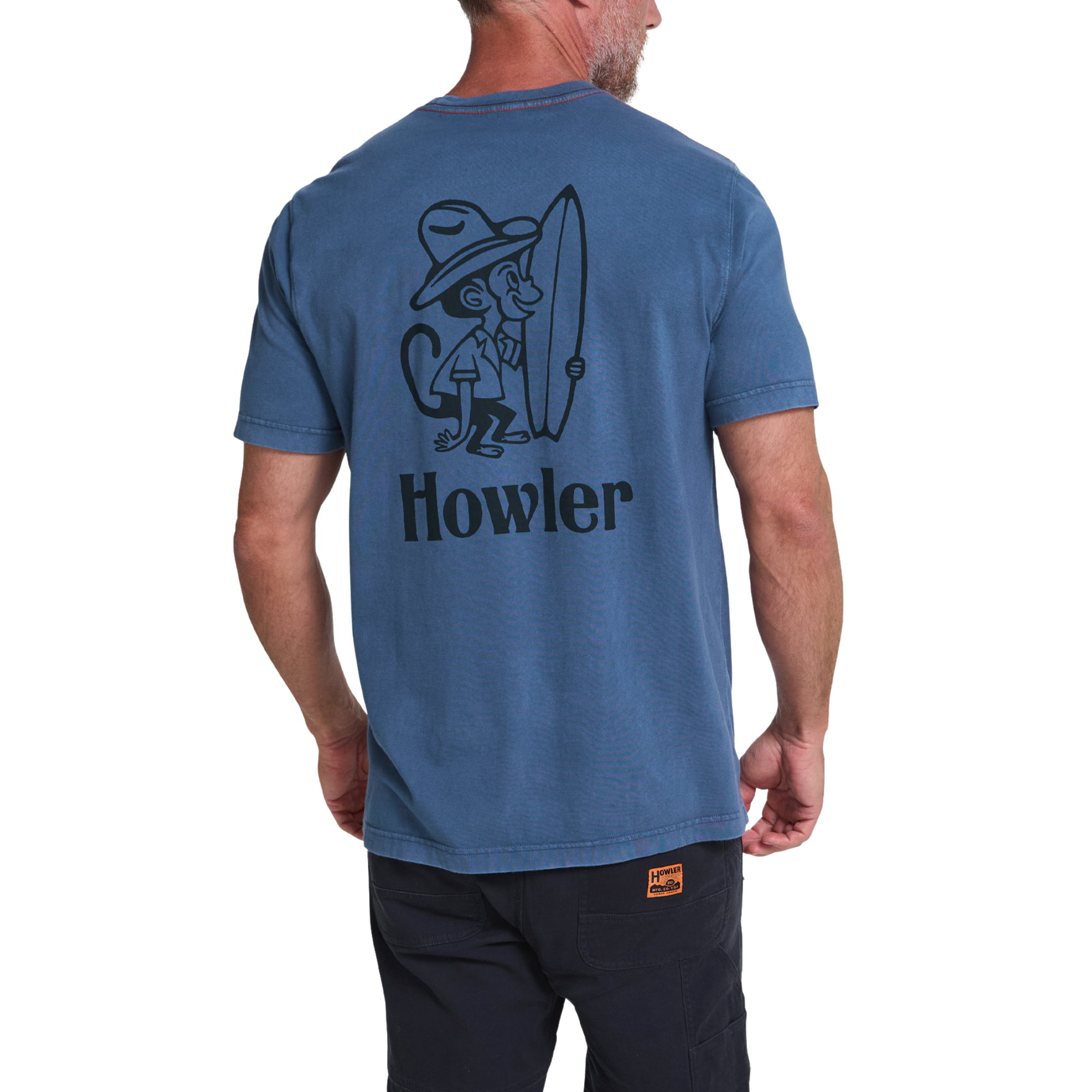 A man wearing a heathered blue t-shirt from the back, featuring a black graphic of a monkey holding a surfboard and the word 'Howler' printed below it.