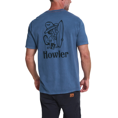 A man wearing a heathered blue t-shirt from the back, featuring a black graphic of a monkey holding a surfboard and the word 'Howler' printed below it.