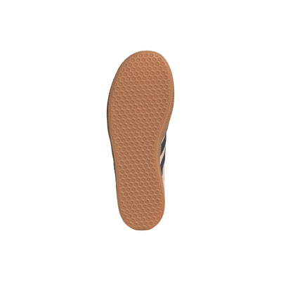 Sole of a Pink Adidas Kids Juniors gazelle sneaker with green accents and three dark blue stripes on a white background