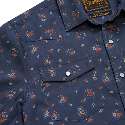 close up of a Holwer Brothers H Bar B Snapshirt Bouquets in a midnight blue wiht small all-over floral print on a white background