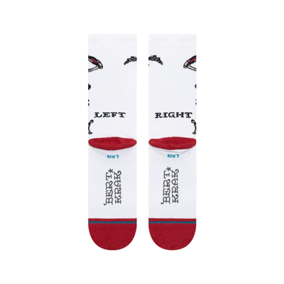 white stance x bert krak crew socks wth a skeleton and skulls and a red toe and heel on a white backgroun
