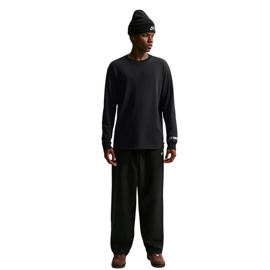 a man wearing a long sleeve Nike SB Yuto Horigome Air Force 1 Skate Tee in Black and a black nike sb beanie on a white background