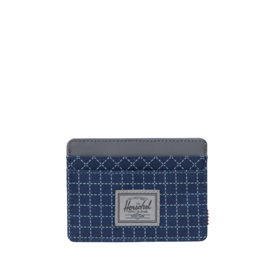 blue herschel charlie card wallet with grid pattern on a white background
