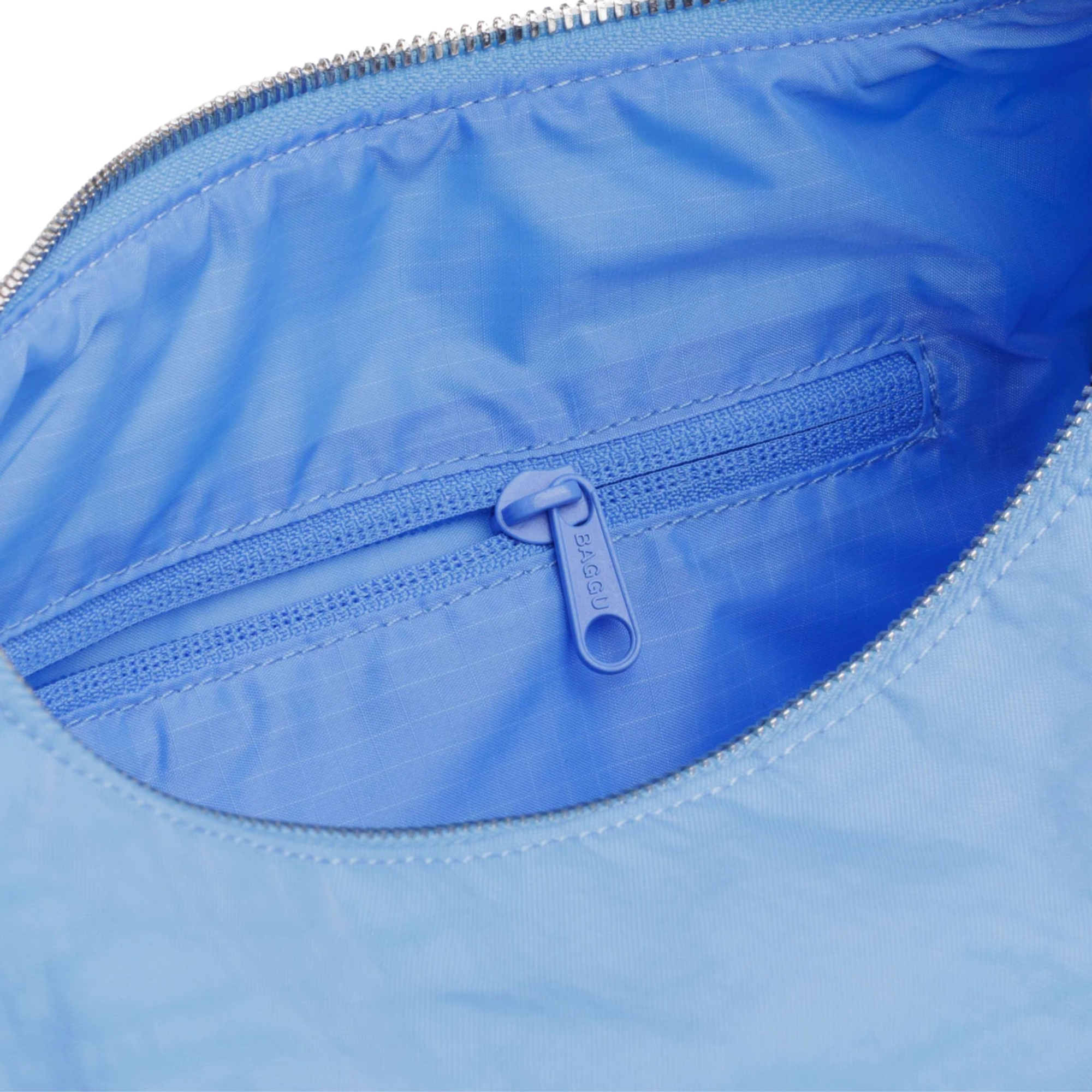Light blue baggu nylon meringue shoulder bag on a white background