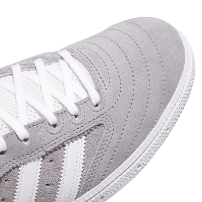Gray Adidas busenitz skateboard sneaker with white stripes on a white background